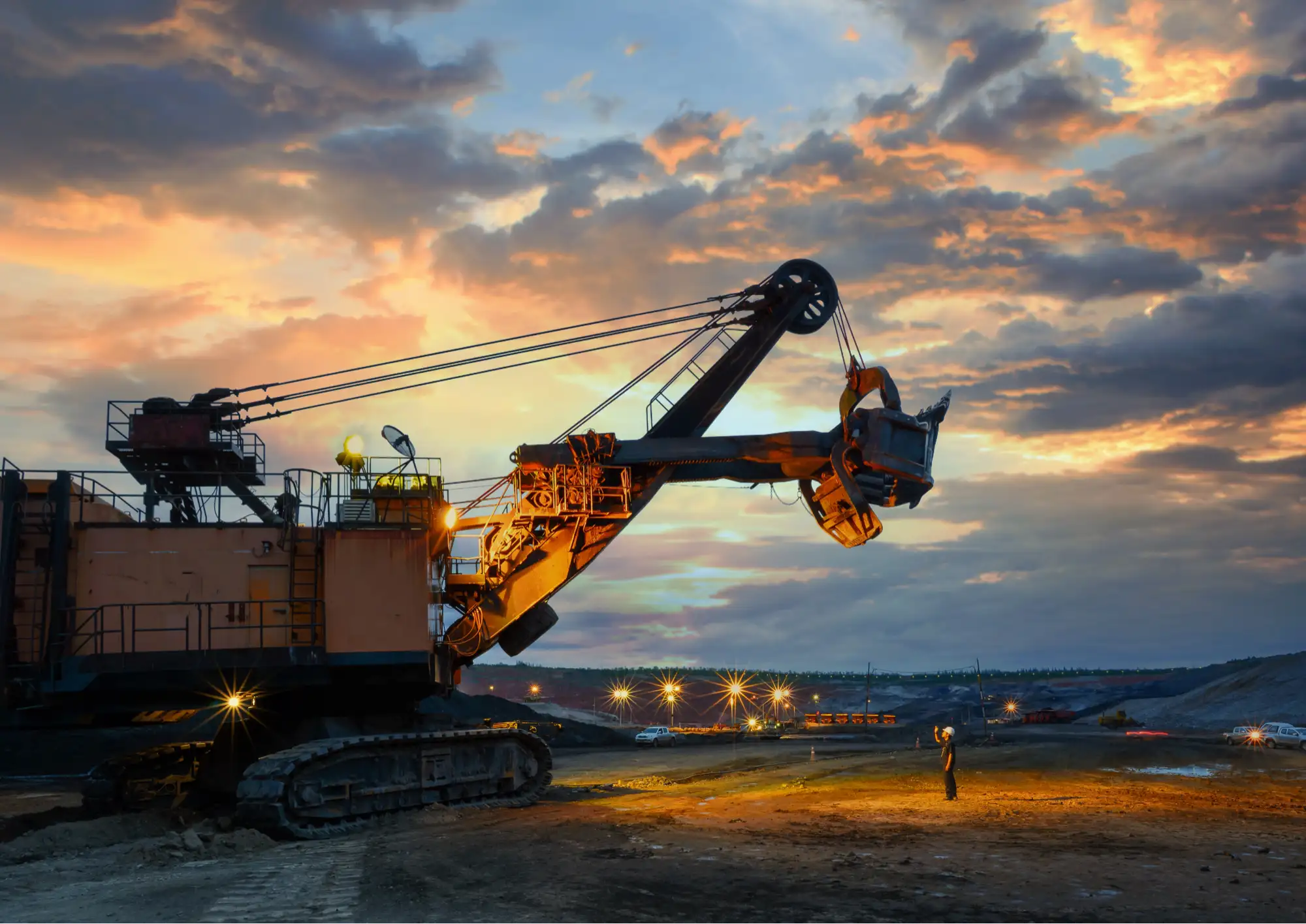 Mining crane silhouetted at sunset